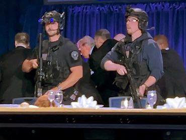 U.S. President Donald Trump is escorted out after a man opened fire with a shotgun on security personnel outside the room, during the annual White House Correspondents' Association dinner in Washington, D.C., U.S., April 25, 2026, in this still image from video. REUTERS/Bo Erickson THIS IMAGE WAS PROCESSED BY REUTERS TO ENHANCE QUALITY, AN UNPROCESSED VERSION HAS BEEN PROVIDED SEPARATELY.     TPX IMAGES OF THE DAY