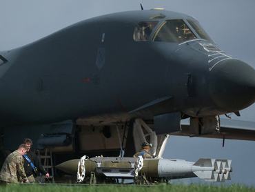 U.S. Airforce (USAF) personnel stand near to munitions and a USAF B-1B bomber, at RAF Fairford airbase, which is used by USAF personnel, amid the U.S.–Israeli conflict with Iran, in Fairford, Gloucestershire, Britain, March 11, 2026. REUTERS/Phil Noble     TPX IMAGES OF THE DAY