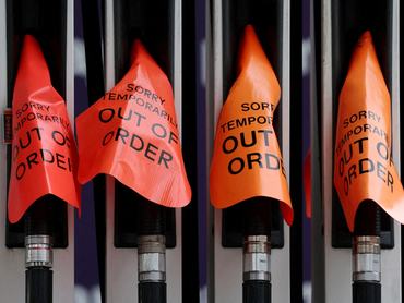 FILE PHOTO: "Out of order" signs cover fuel pumps at a petrol station in Sydney, Australia, March 19, 2026. REUTERS/Hollie Adams/File Photo