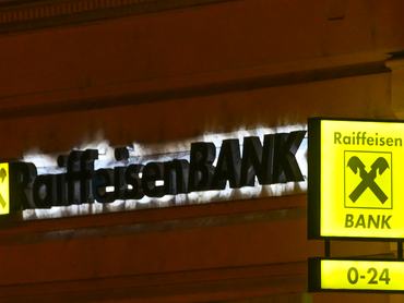 BUDAPEST, HUNGARY  MARCH 4: The illuminated yellow logo and '0-24' ATM signage of Raiffeisen Bank are seen on a building in Budapest, Hungary, on March 4, 2026. (Photo by Artur Widak/NurPhoto via Getty Images)
